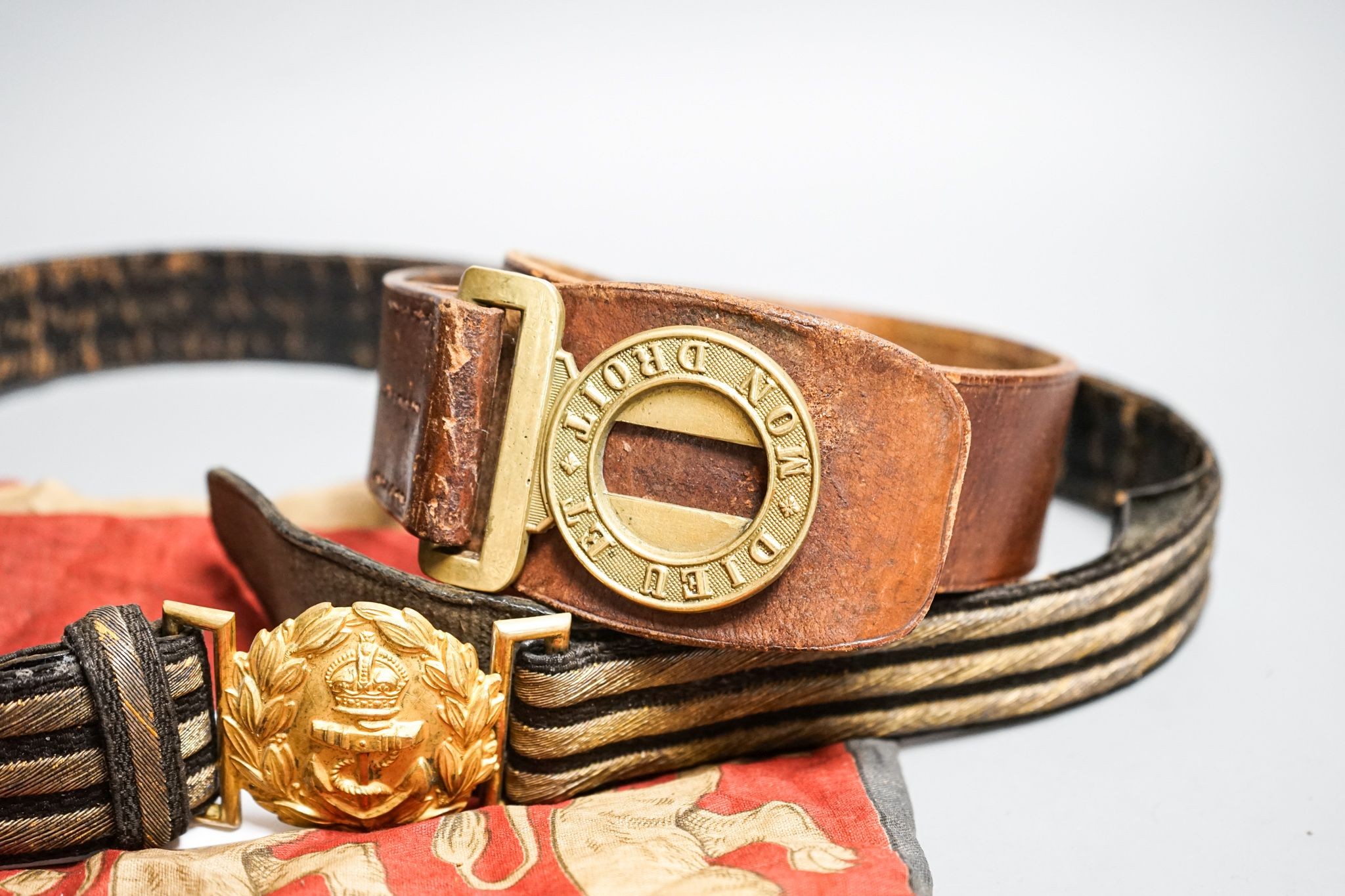 A Royal Naval gilt brass mounted officers belt and an Edwardian Dieu et mon droit belt and a Victorian printed flag